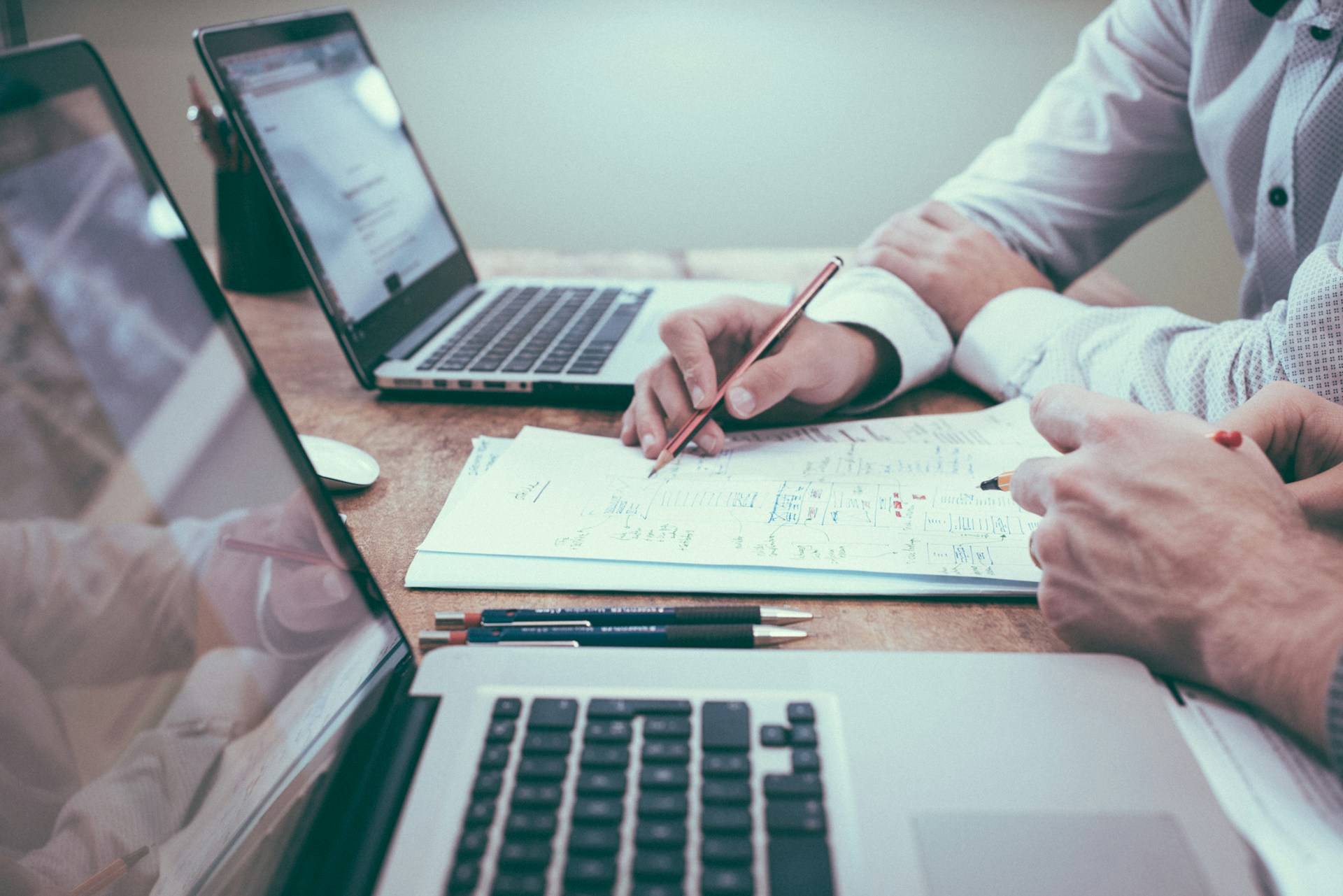 Business advisors reviewing due diligence documents and financial notes